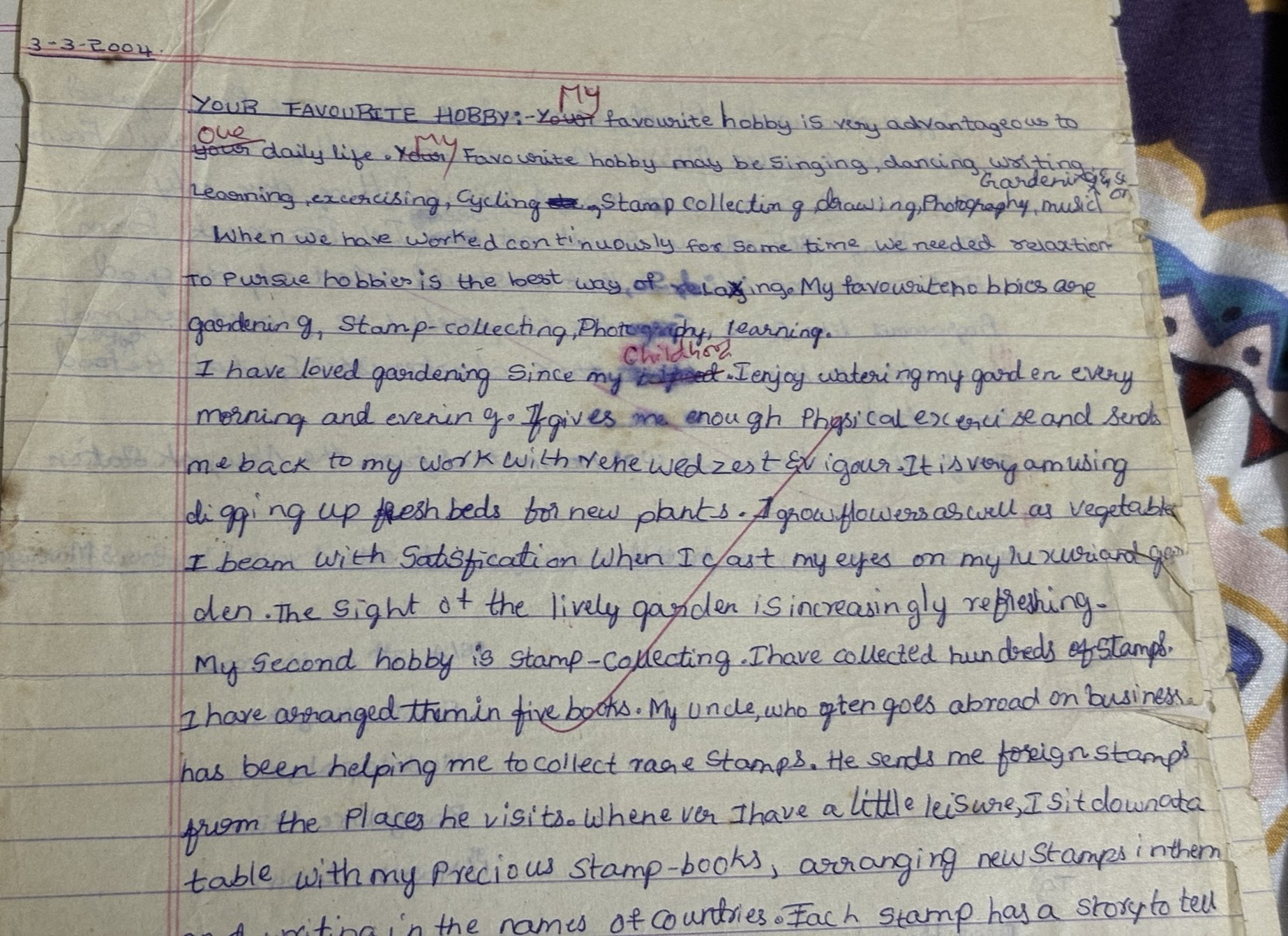 Handwritten essay titled Your Favourite Hobby, with the teacher's red corrections changing Your to My.